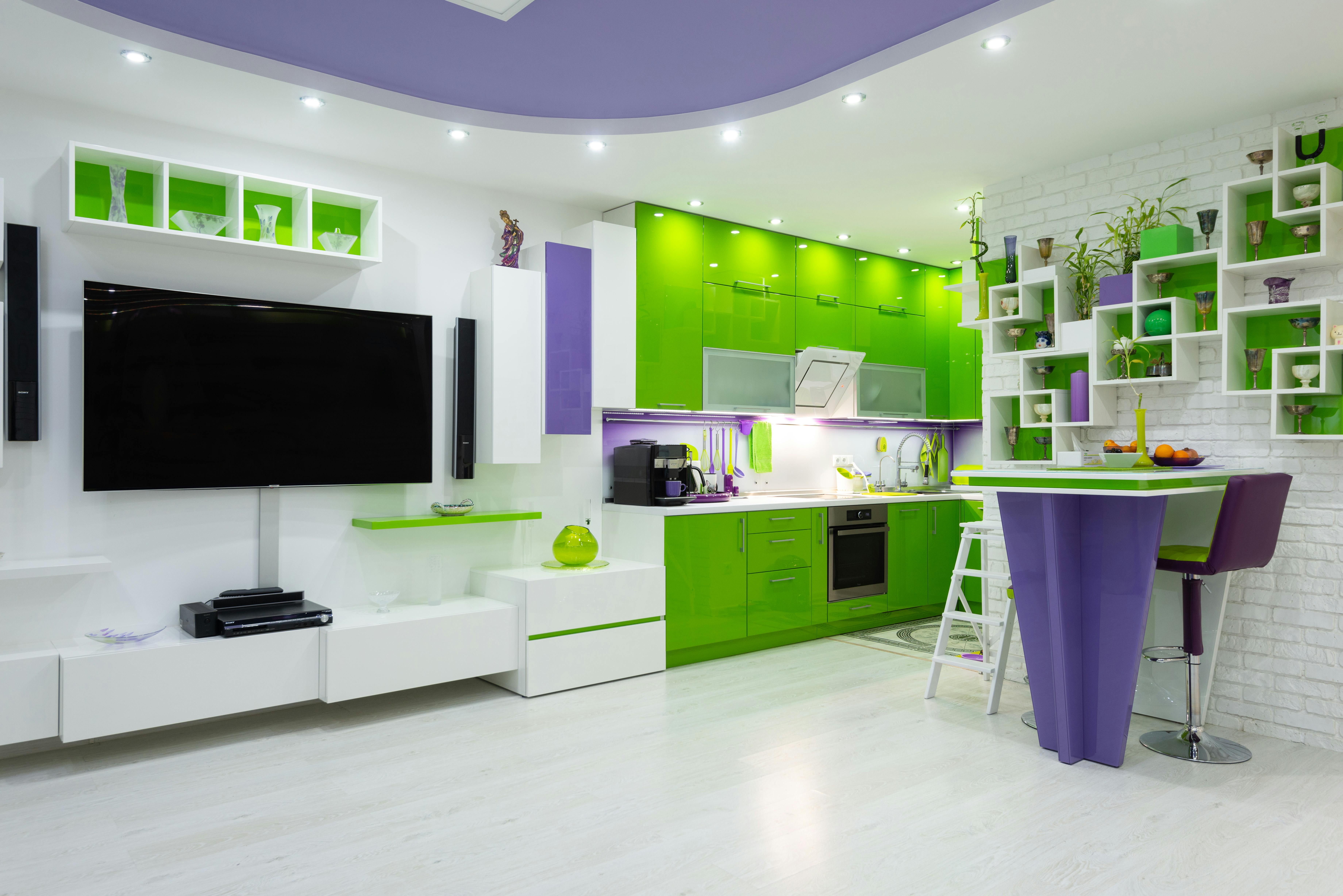 bright green and purple furniture in contemporary studio apartment with kitchen area