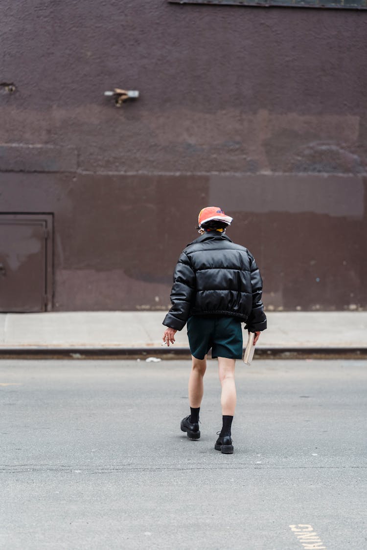 Unrecognizable Cool Woman In Jacket Crossing Road In Town