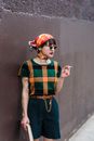 Trendy ethnic student with copybook and cigarette on street