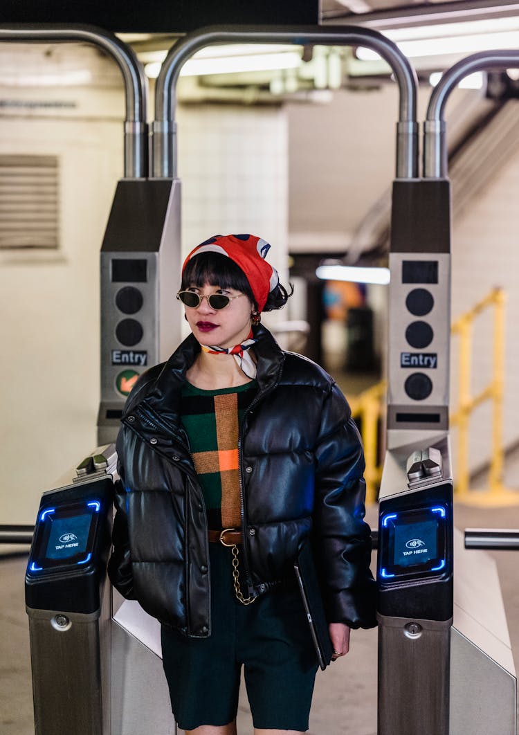 Stylish Asian Woman In Sunglasses Passing Through Turnstile