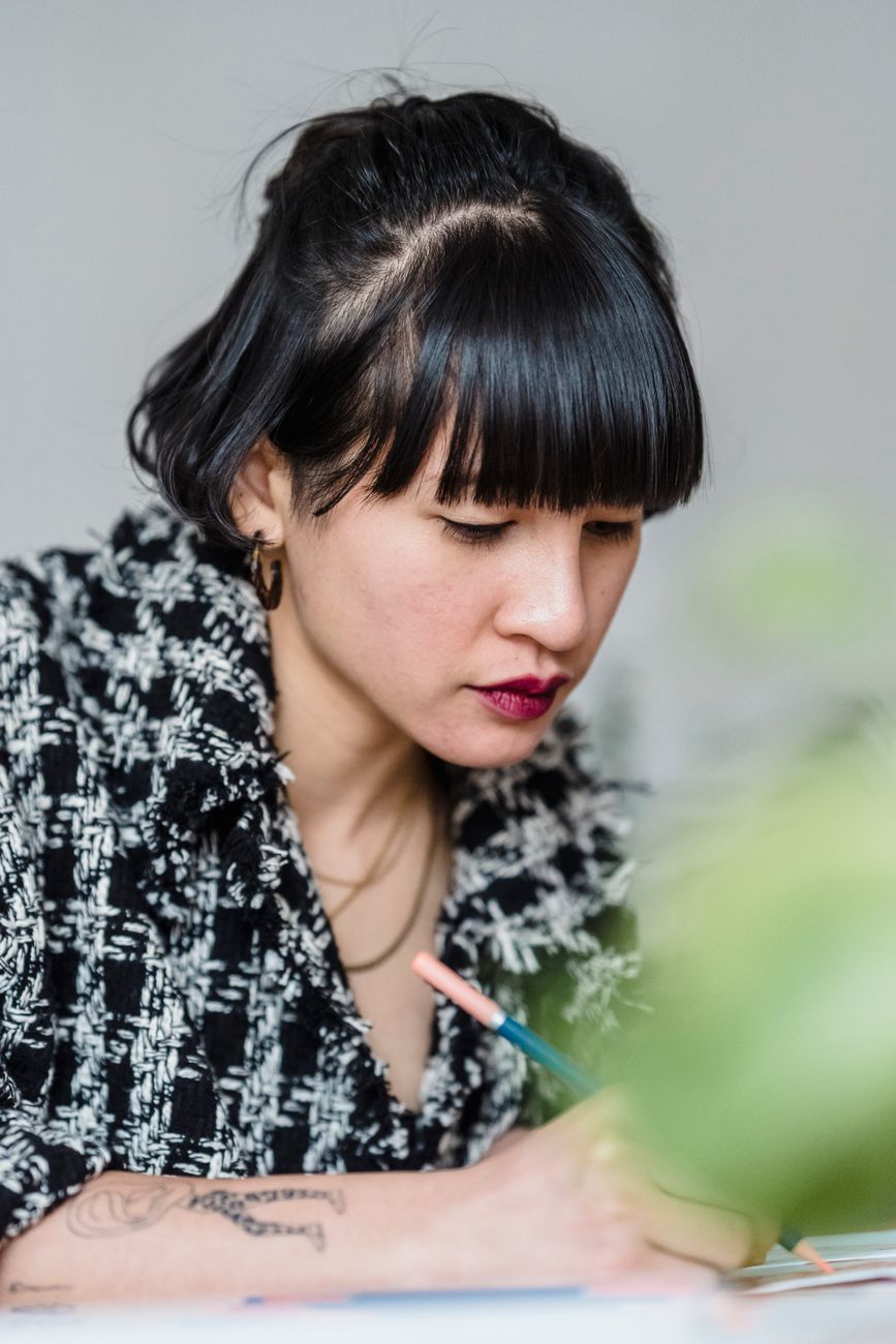 A designer concentrating on an illustration at her desk