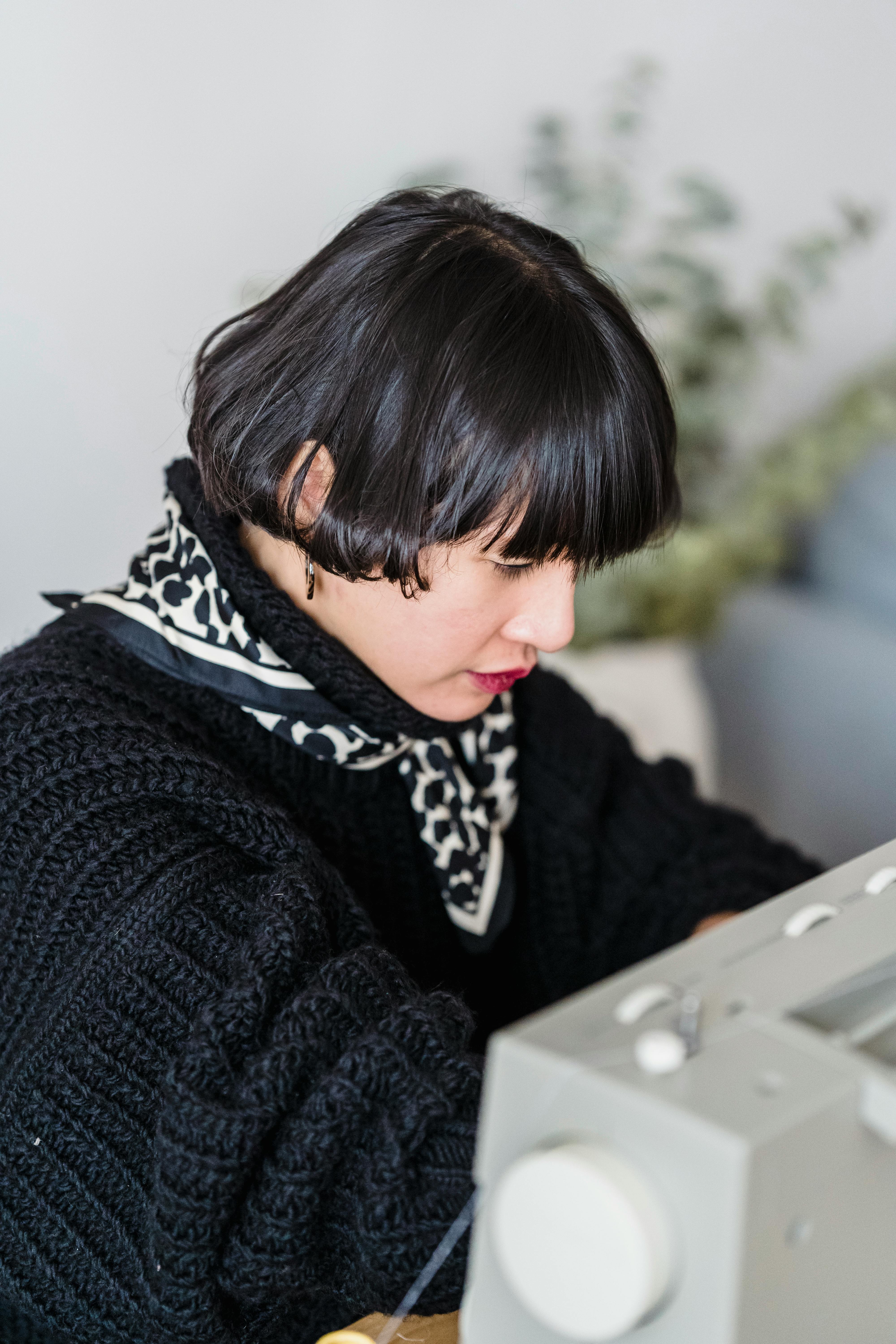 skilled asian woman working on sewing machine