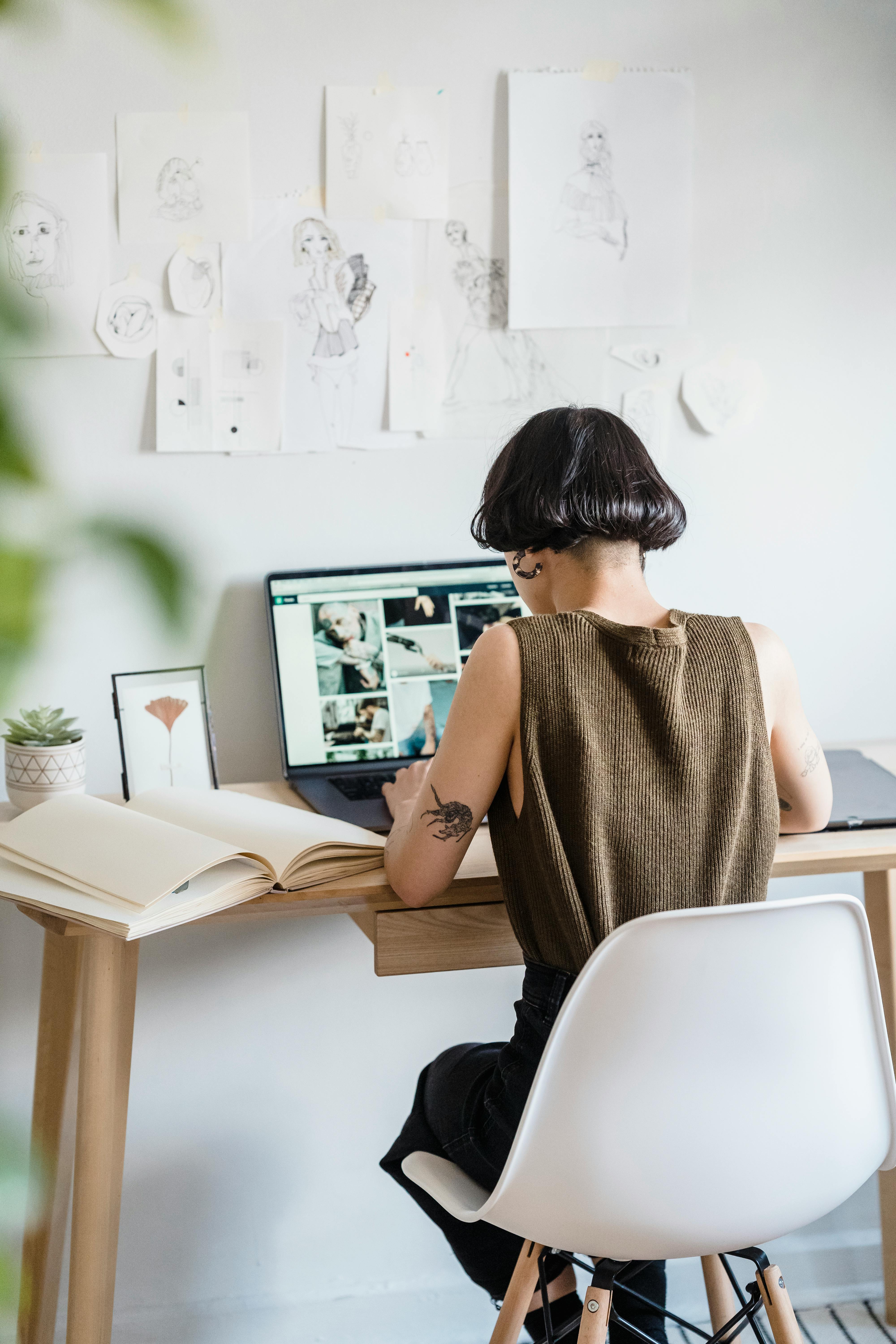 anonymous female freelancer using netbook in light workshop