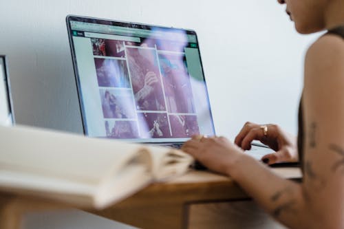 Female freelancer sitting at table and working on laptop