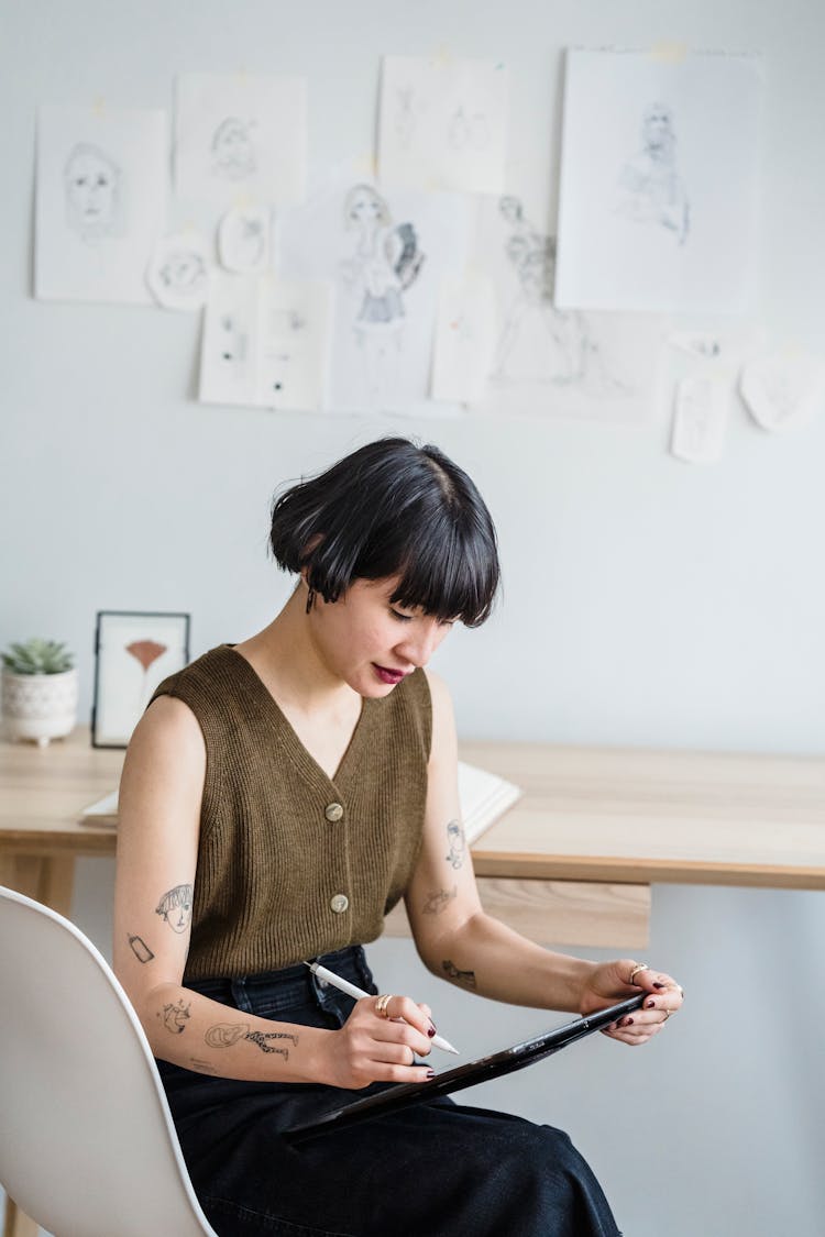 Serious Lady Making Sketches On Graphic Tablet