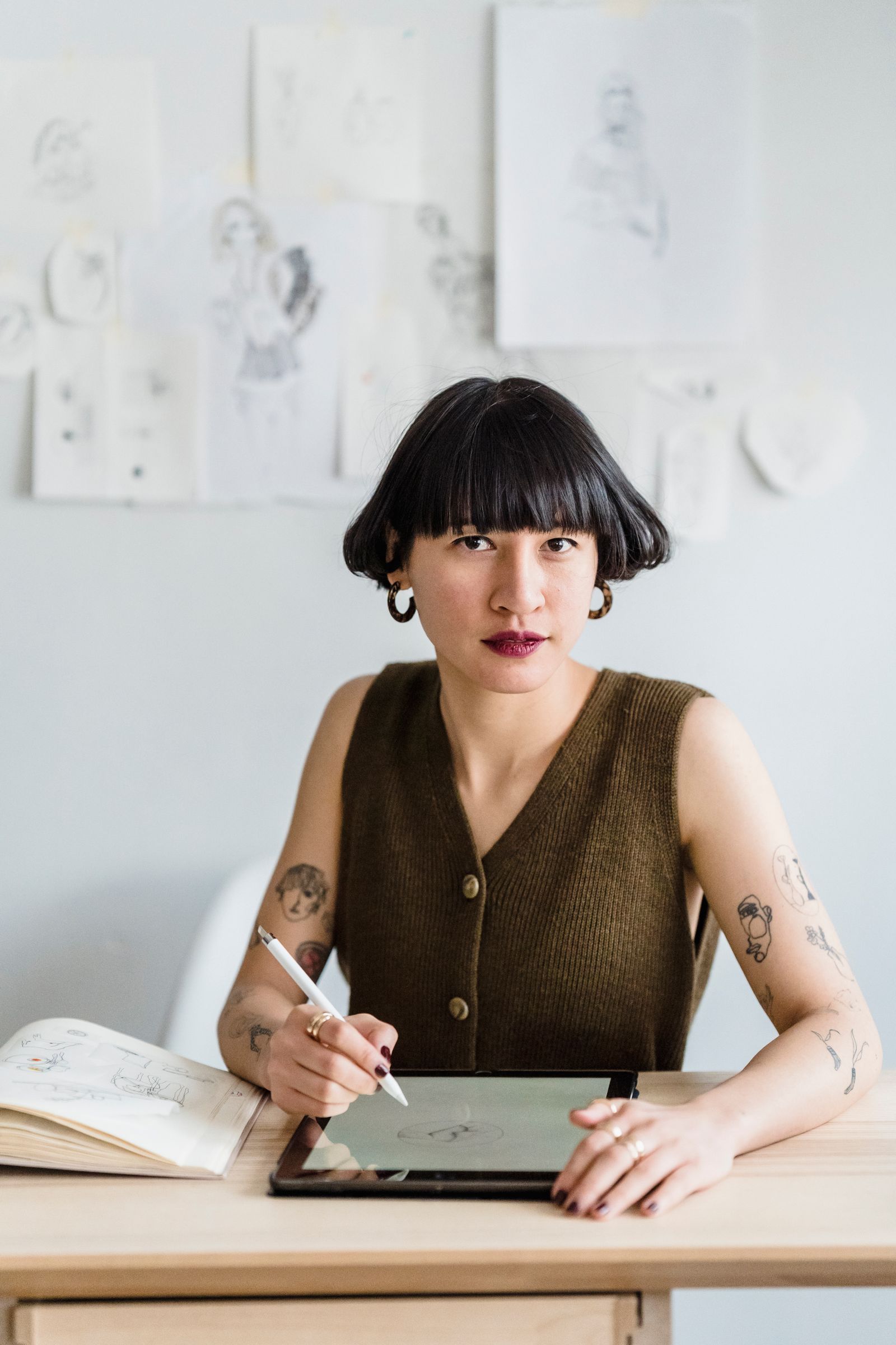 A designer looking up from her desk in a studio