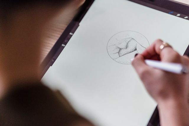 Artist drawing a stippled sketch with a stylus on a tablet, photo by Michael Burrows on Pexels