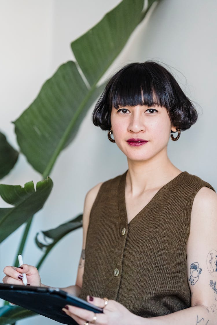 Stylish Ethnic Woman Using Graphic Tablet In Studio