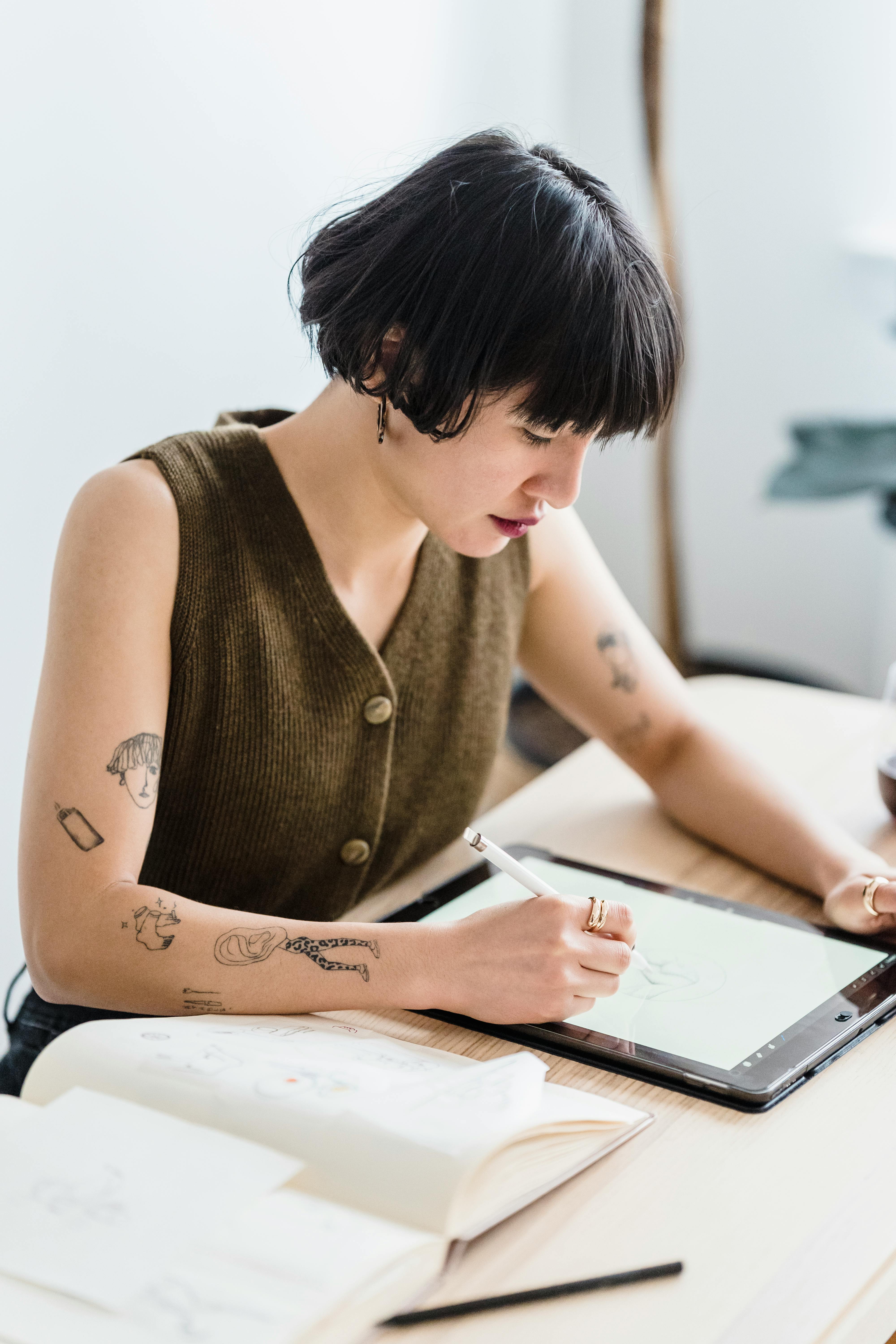 young focused woman taking notes in tablet