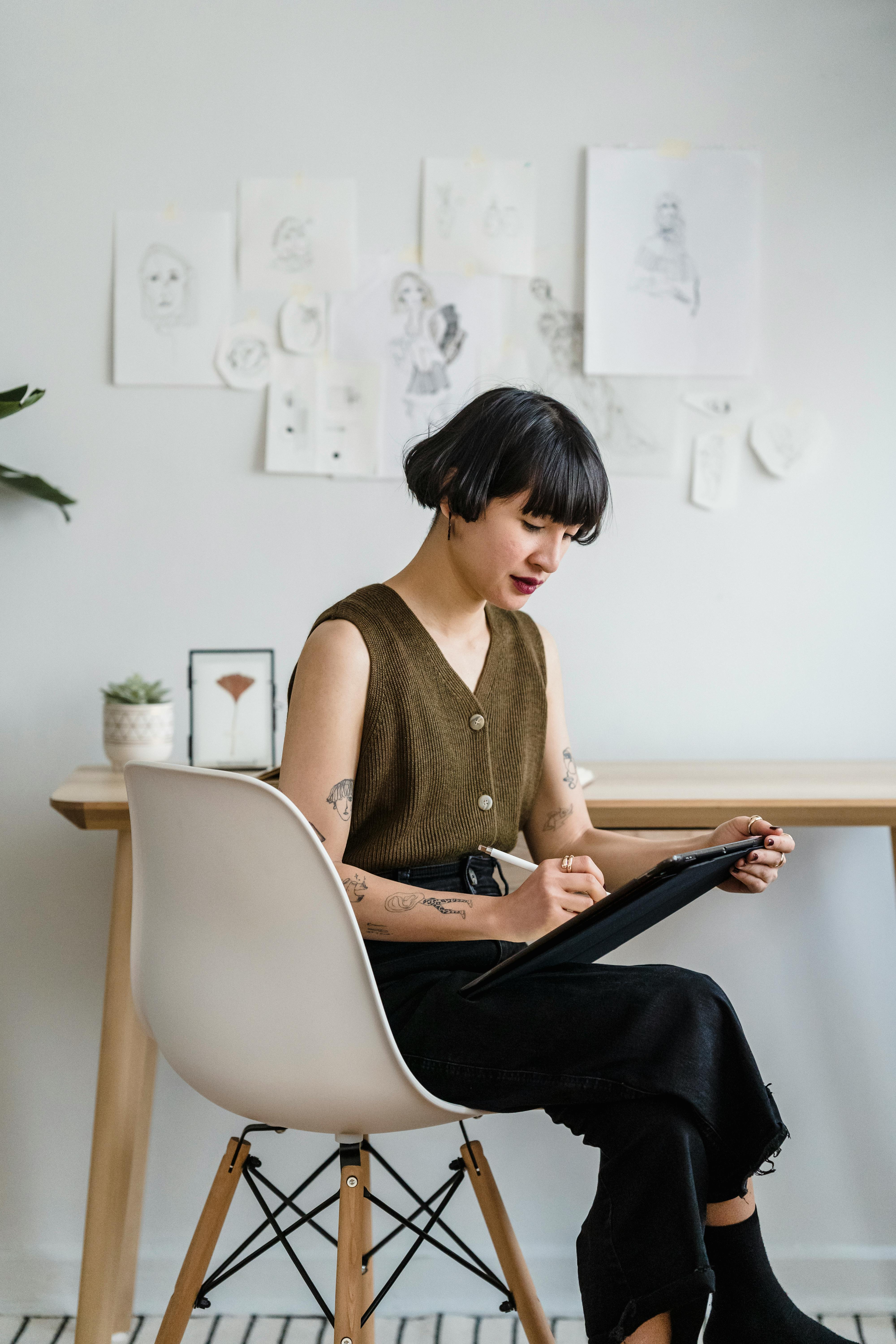 young woman taking notes on tablet