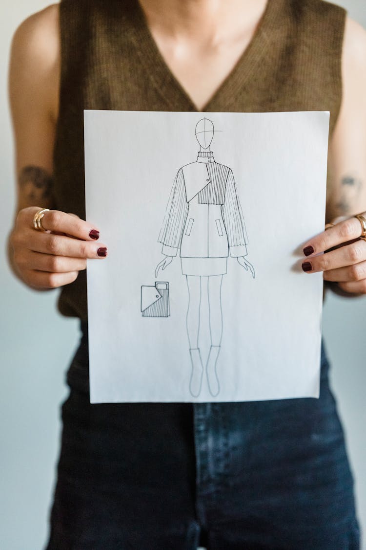 Anonymous Woman Showing Sketch Of Trendy Stylish Outfit