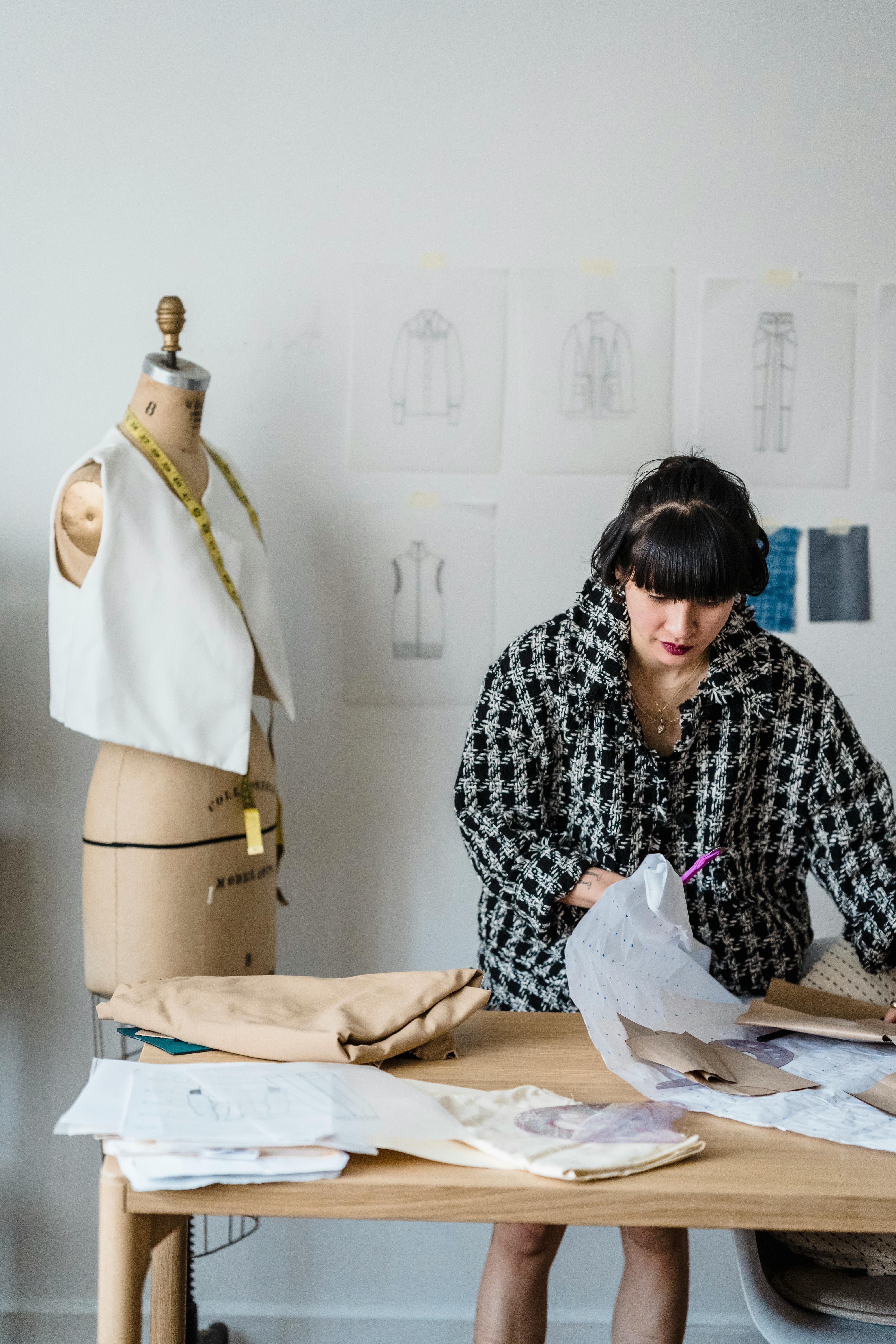 woman sewing clothes in atelier