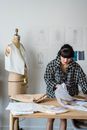 Woman sewing clothes in atelier