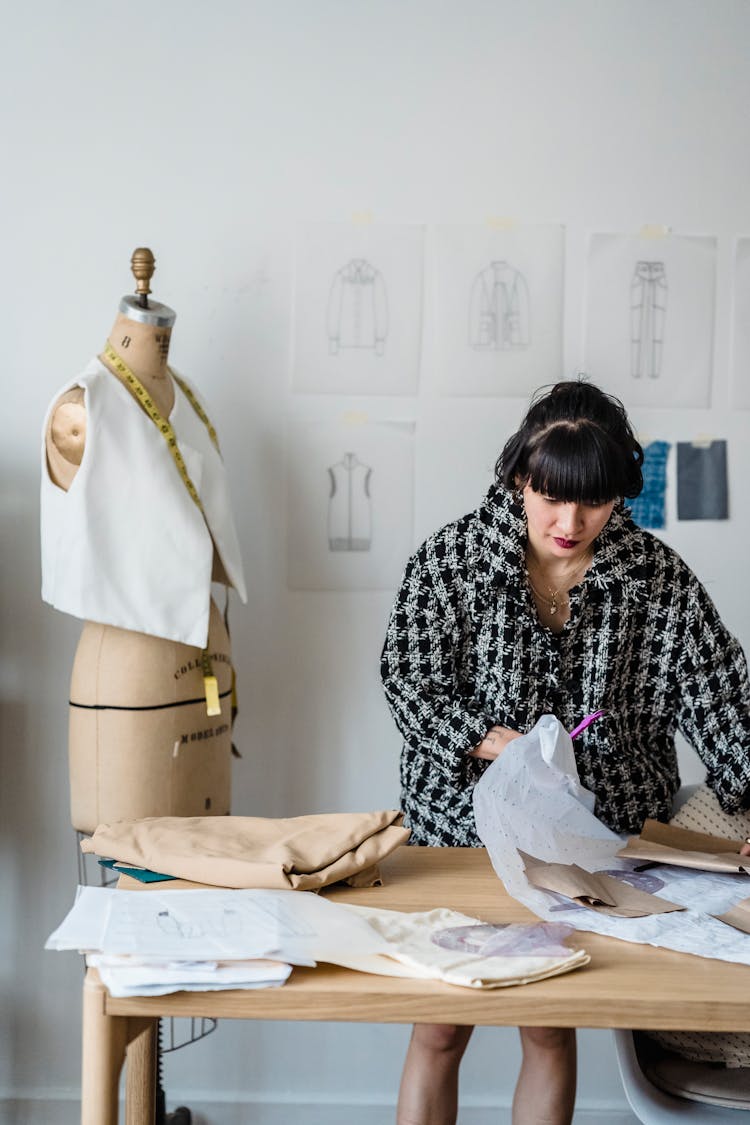 Woman Sewing Clothes In Atelier