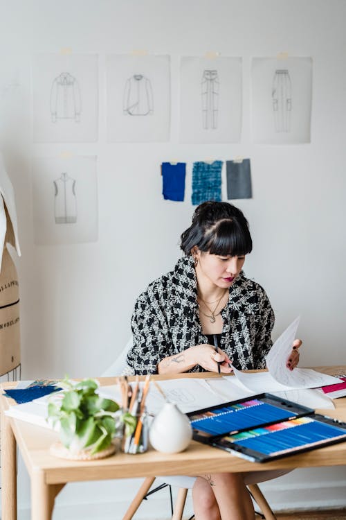 Woman looking at papers in workshop