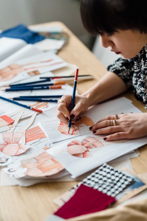 Fashion sketches and colourful fabrics on the studio table