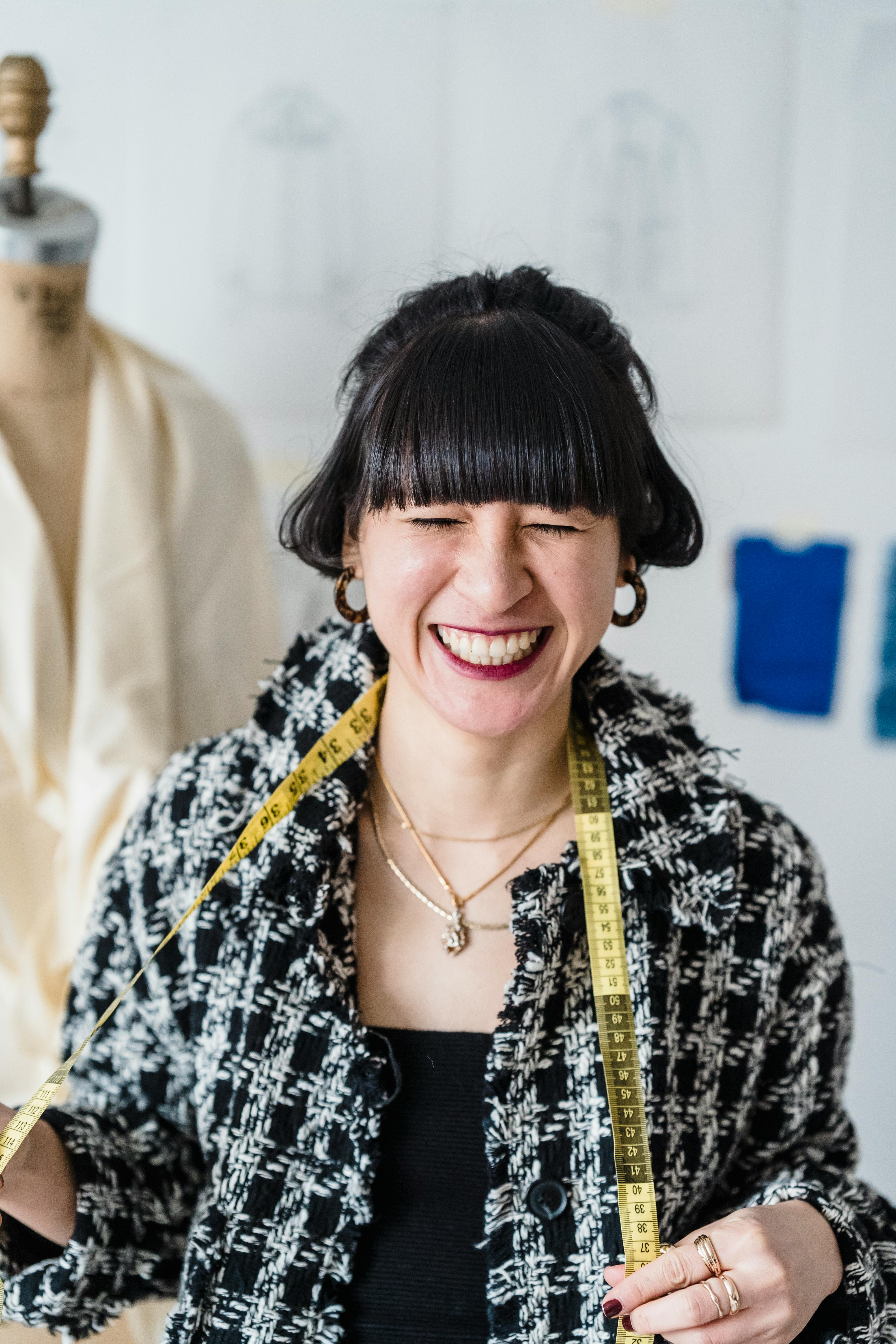 smiling asian woman with measuring tape