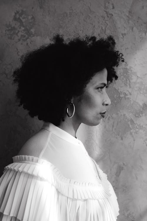 Monochrome Photo of the Side View of a Woman with Afro Hair