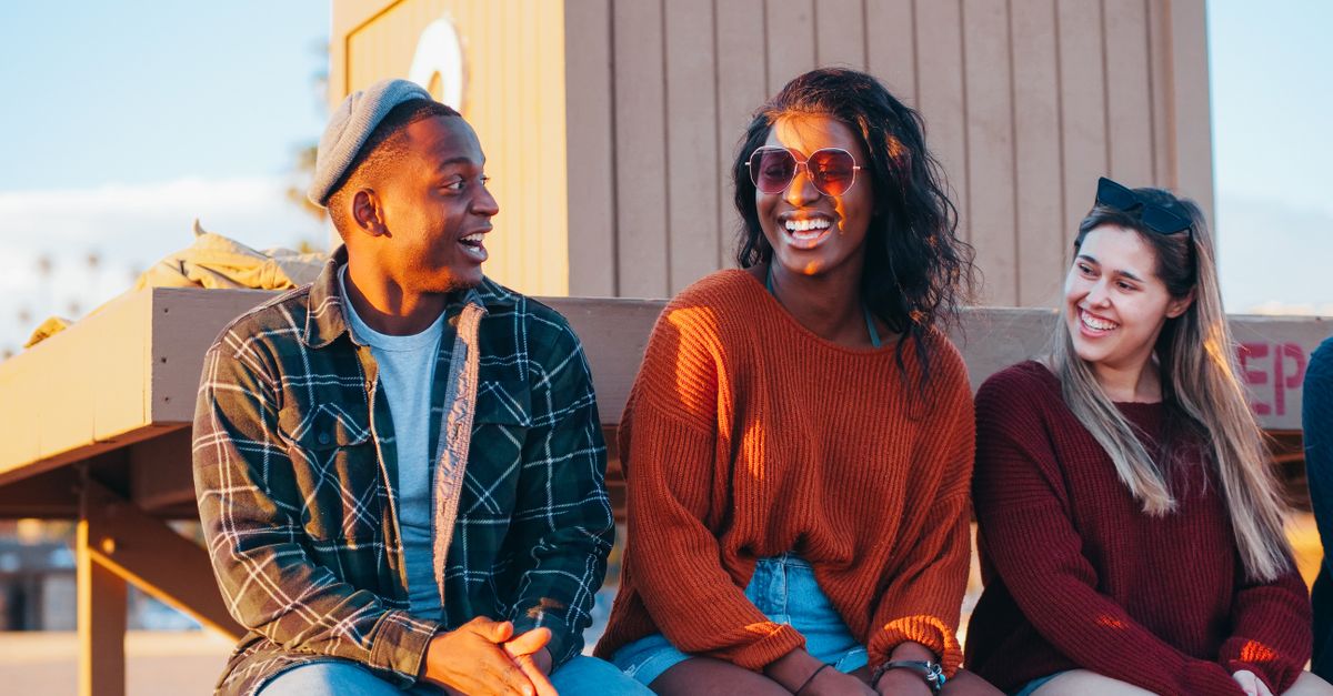 Group of young people laughing and talking outside Christ Embassy Loveworld Arena in Ho