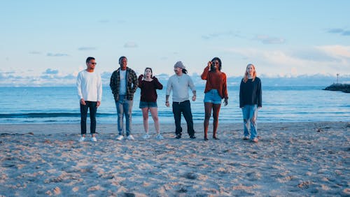 Group of Friends Standing on Beach Shore
