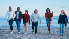Group of Friends Walking on Beach Shore