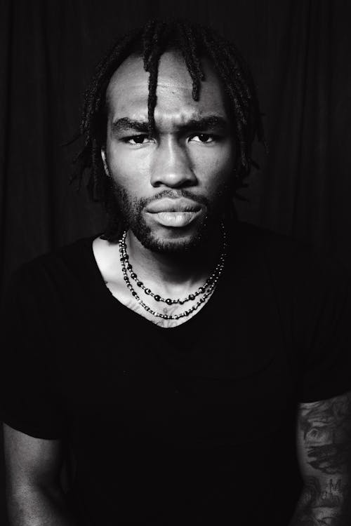 Grayscale Photo of a Man Wearing Black Shirt