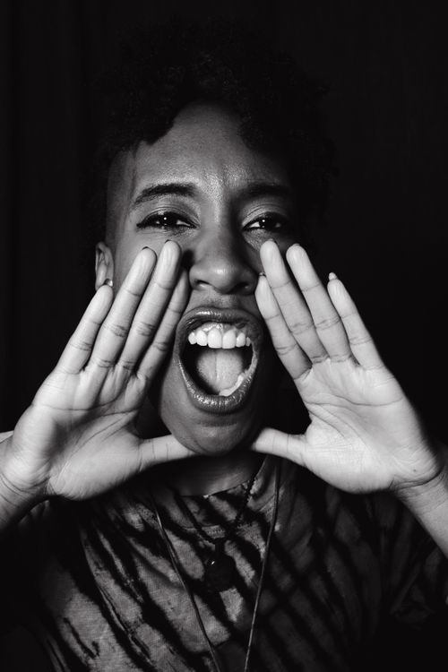 Free Grayscale portrait of a black woman energetically shouting, conveying strong emotions. Stock Photo