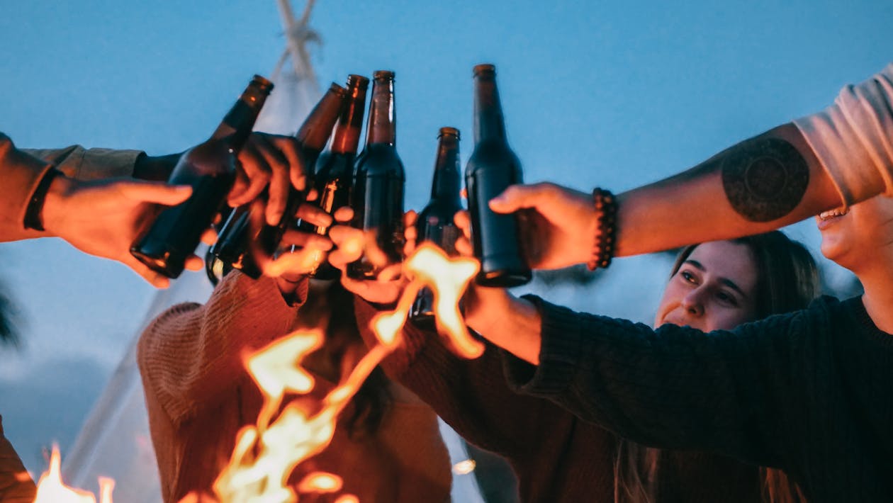 Free Group of Friends Clinking Beer Bottles Stock Photo