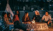 Group of Friends Sitting in Front of Fire Pit