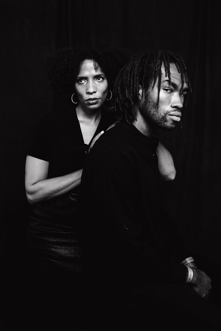 A Couple In Black Clothes On Dark Background