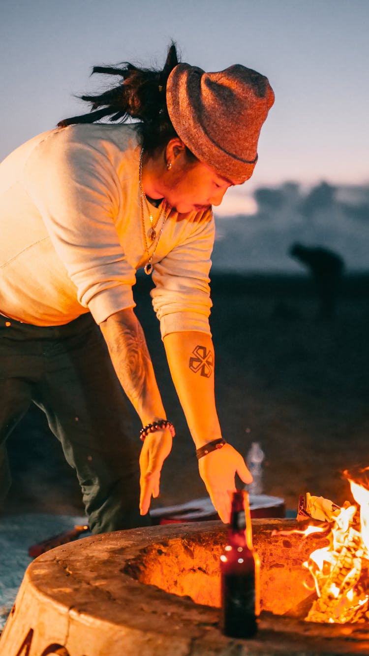 Man Warming Hands By Fire