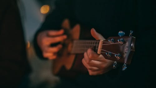 Free Person Playing Brown Acoustic Guitar Stock Photo