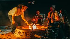 Group of Friends Sitting in Front of Fire Pit