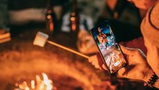 Man Recording on His Smartphone Women Roasting Marshmallow
