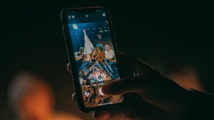 Person Taking Photo Of Group Of Friends