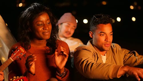 Group of Friends Singing while Sitting Outdoors