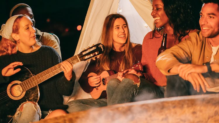 Group Of Friends Singing While Having A Bonfire