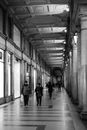 Anonymous citizens walking in corridor of old building