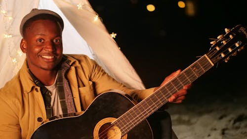 Man Holding a Acoustic Guitar