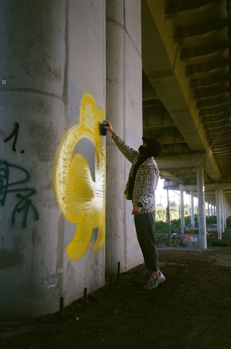 Man Spraying Paint On Wall