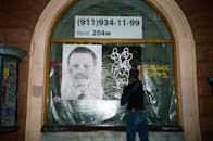 Man Posing a Poster at a Window