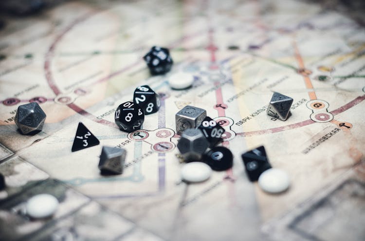 Black And Gray Dice On White Board Game 