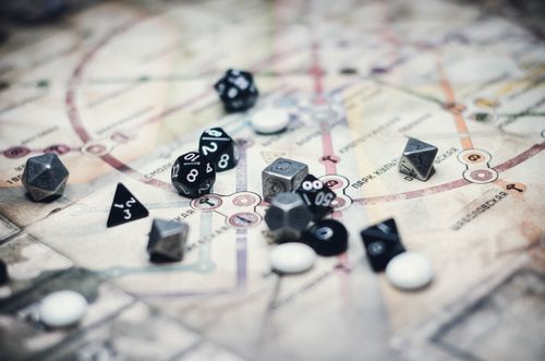 Free A collection of multi-sided dice on a detailed map, ideal for gaming enthusiasts Stock Photo