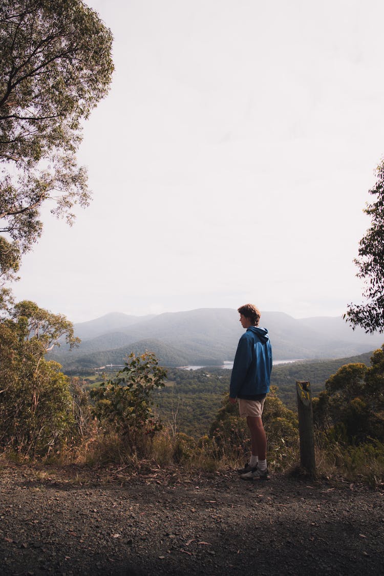 Man In Blue Long Sleeve Shirt Standing On Soil