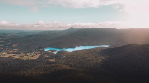 Aerial View of Mountains Under Cloudy Sky