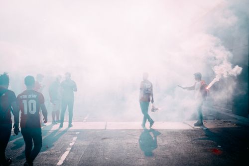 Free Soccer fans in İstanbul celebrate with smoke flares, creating a dynamic and vibrant atmosphere. Stock Photo