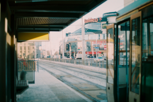 Free A tram waiting at a snowy stop with cityscape backdrop in central Minsk, Belarus. Stock Photo