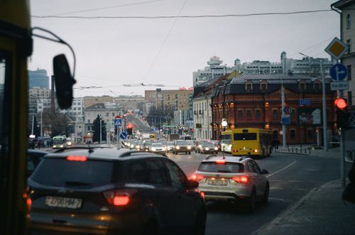 Free City traffic at dusk in downtown Minsk, Belarus, featuring vehicles and historic architecture. Stock Photo