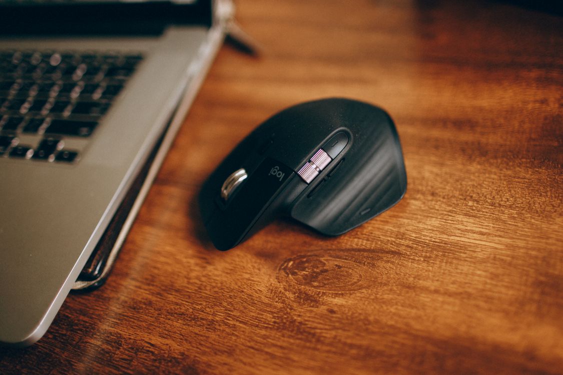 Black Cordless Computer Mouse on Brown Wooden Table · Free Stock Photo