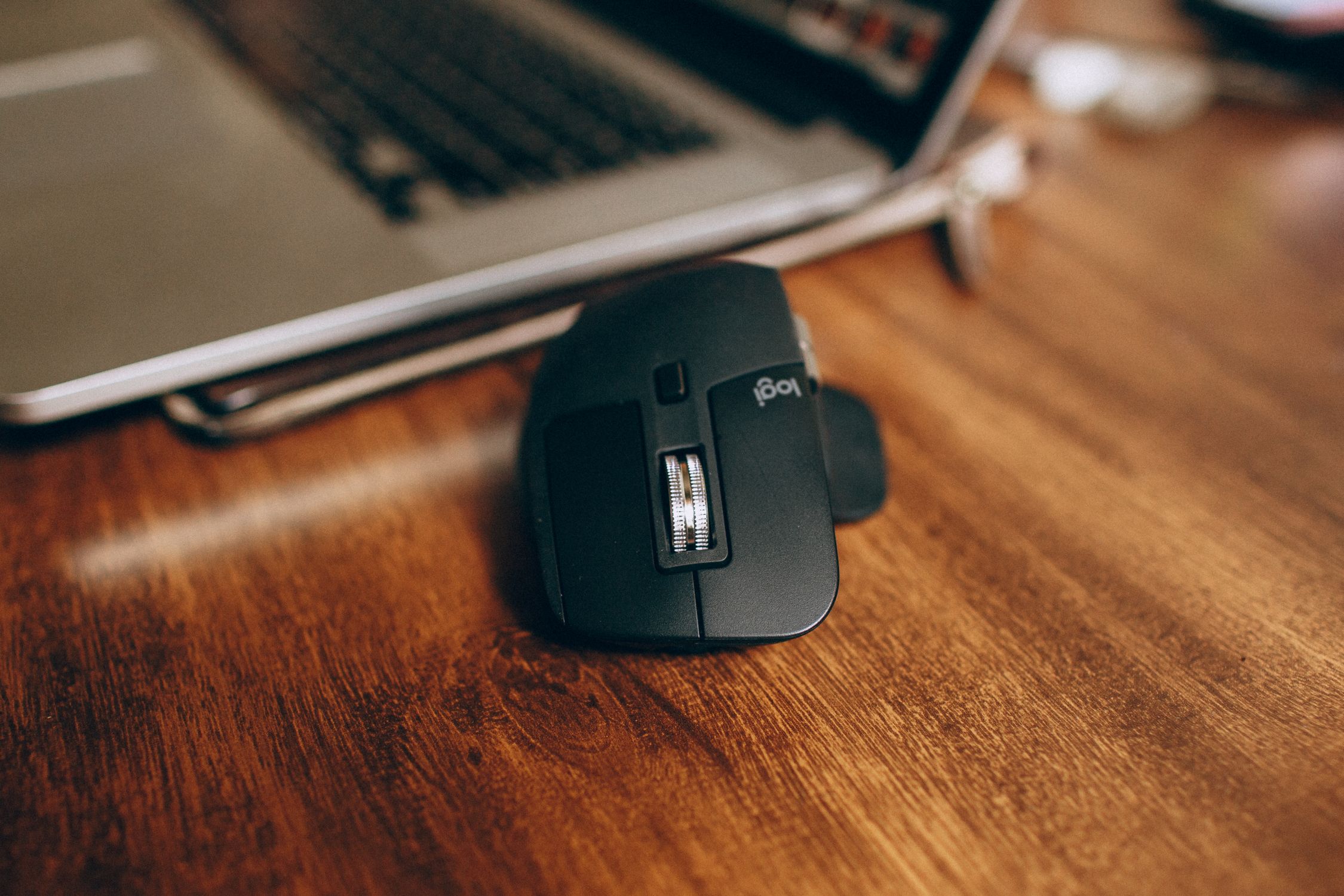 Black Wireless Computer Mouse on Brown Wooden Desk · Free Stock Photo